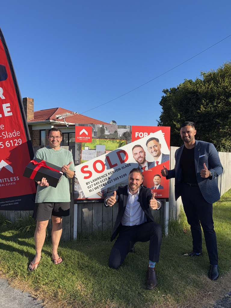 Sold sign with happy sellers
