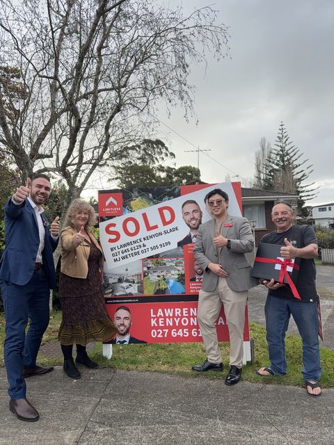 Sold sign with happy sellers