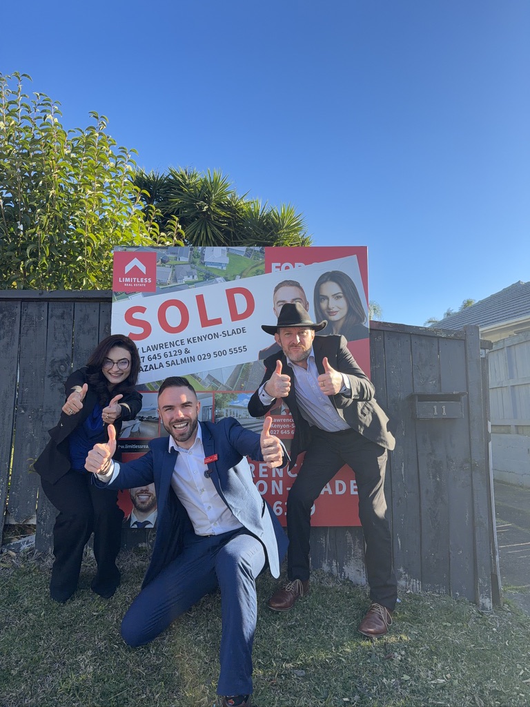 Sold sign with happy sellers
